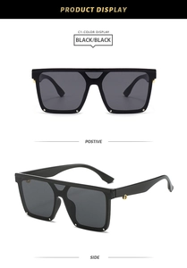 Detail view of square oversized black sunglasses with gold rivets on polished frame