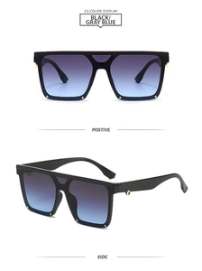 Detail view of square oversized sunglasses with blue gradient lenses and gold ornaments