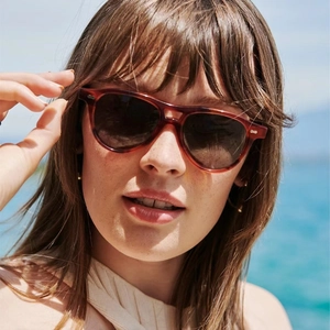 Detail shot of vintage double-bridge pilot sunglasses with tortoiseshell frame on a model