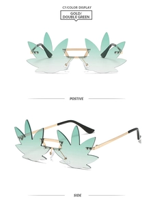 Detail of rimless leaf-shaped party sunglasses with green gradient lenses and gold frame