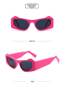 Macro detail of rose red geometric sunglasses featuring wide temples and dark lenses