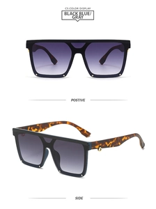 Detail of oversized square sunglasses featuring tortoiseshell temples and silver rivets