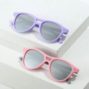 Detailed close-up of purple and pink matte fashion sunglasses on a minimalist white stand
