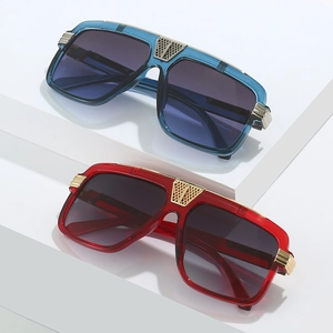 Close-up of square sunglasses with hollow gold metal details and transparent frames