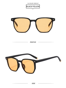 Lunettes de soleil rétro à monture noire et verres jaunes avec détails dorés aux branches