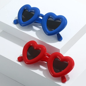 Close-up of heart-shaped sunglasses in bold blue and red colors with thick glossy frames