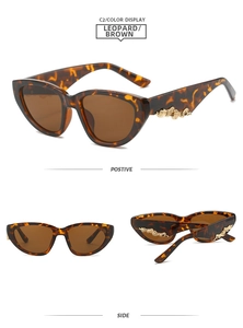 Detail of leopard print cat eye sunglasses with golden wave metal accent on temples