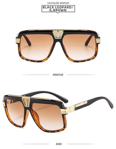 Detail view of oversized black leopard sunglasses with gold accents and gradient brown lenses