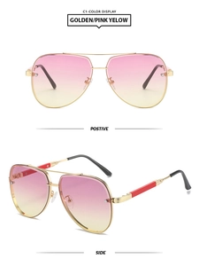 Detail of square aviator sunglasses with gold metal frame and pink gradient lenses