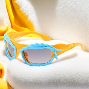 Detail of Y2K sunglasses with yellow frame and blue wavy trim on fuzzy background