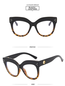 Detailed view of cat eye glasses with black leopard print and gold hardware accents