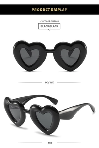 Front and side view of Y2K puffy heart sunglasses in sleek black plastic frames