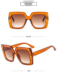 Detail view of square leopard print sunglasses with brown gradient lenses and gold rivets