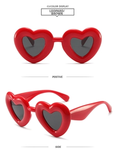 Detail view of red heart-shaped sunglasses with thick frames from front and side angles