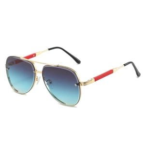Fashionable square pilot sunglasses with gold metal frames and blue-green gradient lenses