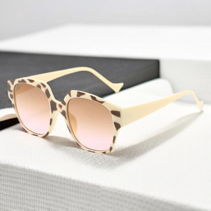 Detail of cream temples and tortoise frame sunglasses with pink gradient lenses