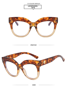 Detail of leopard print cat-eye glasses frame with golden metal decoration