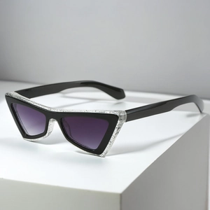 Detail of cat-eye sunglasses with ice-crack textured frames and purple gradient lenses