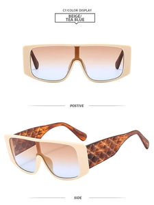 Dettaglio occhiali a maschera beige con lenti sfumate blu tè e stanghette con trama a rombi