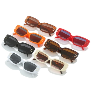 Detail view of seven vintage rectangular sunglasses with gold rivets on chunky frames