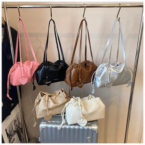 Showcase of six pleated dumpling bags in pink, black, tan, silver, beige, and white colors