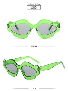 Detail view of avant-garde Y2K wavy green jelly sunglasses with dark grey lenses