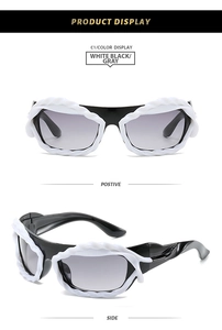 Detailed view of white wavy sunglasses frame with stylish grey gradient lenses