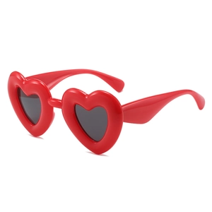Chunky red heart shaped sunglasses with thick frame and dark lenses for Y2K style