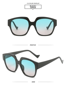 Detail view of bold black square frame sunglasses with blue to pink gradient lenses