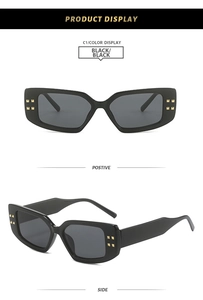 Detail of black square sunglasses with golden rivets on the thick frame, front and side views