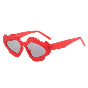 Y2K lip shaped sunglasses in vibrant red jelly frame with gray lenses for party outfits