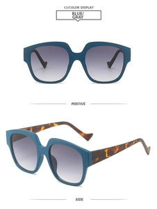 Detail view of stylish dark blue geometric sunglasses with tortoiseshell temples and grey lenses