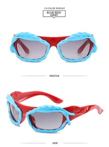 Detail of Y2K style sunglasses with red frames and blue textured braided edge accents