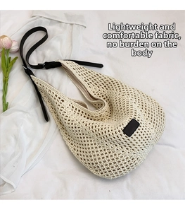 Detailed top view of a minimalist cream crochet hobo bag with slim black leather straps