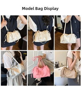 Detail showing various colors of pleated crossbody bucket bags with heart-shaped charms