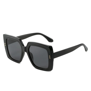 Fashionable oversized square black sunglasses with luxury wood grain texture and gold dots