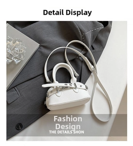 Detail of white lychee pattern mini shell bag with silver hardware and shoulder strap