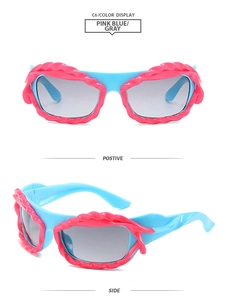 Detail view of bold Y2K style blue and pink wavy contrast sunglasses with gray lenses