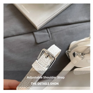 Detail of adjustable white litchi leather strap with polished silver metal buckle