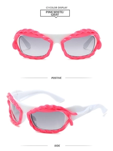 Detail of pink and white Y2K style sunglasses with unique wavy textured frames