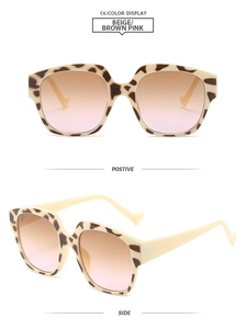 Detail view of beige leopard frame sunglasses with brown pink gradient lenses