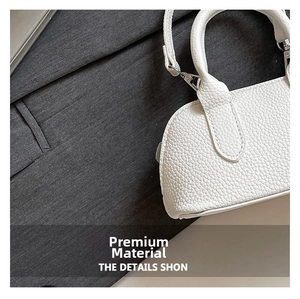 Close-up of white litchi pattern mini bag with silver metal hooks and clear texture