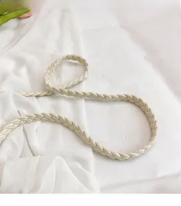 Close-up of beige woven shoulder strap featuring a smooth braided crochet texture detail