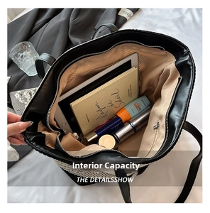 Detailed view of the spacious interior of a striped woven tote bag with daily essentials