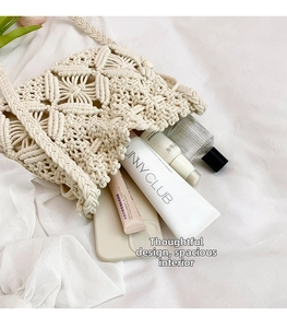 Detail view showing the spacious interior and crochet knit texture of this ivory beach bag