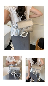Detail of silver metallic backpack featuring lace heart charm and adjustable straps
