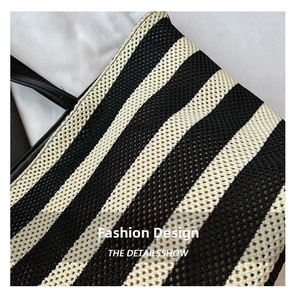 Detailed macro view of black and beige striped woven tote bag mesh fabric texture