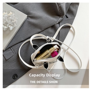 Internal view of white shell bag showing capacity for lipstick and cosmetics