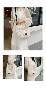 Detailed close-up of cream woven hobo tote bag featuring adjustable black leather strap