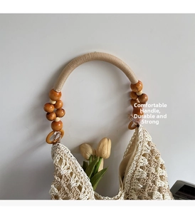 Detail of hand-woven beige tote with a braided wood bead handle and tulip accent